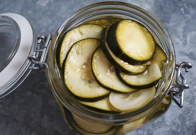 An overhead shot of a glass jar filled with easy refrigerator pickles.