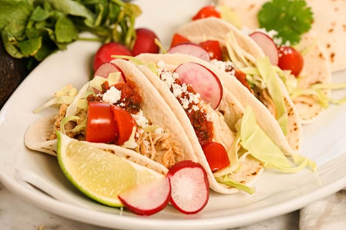 Slow Cooker Shredded Chicken Tacos on a white platter.