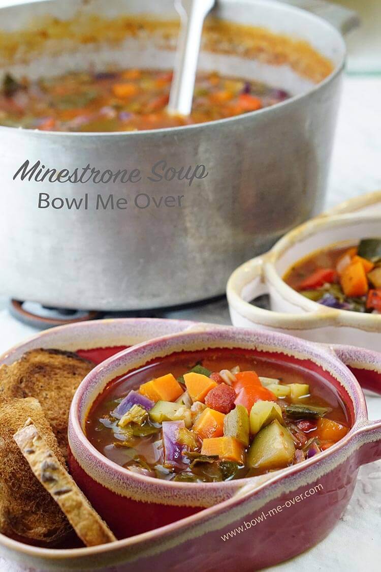 Two bowls of homemade soup served up with toast points on the side. There's also a big pot of soup so everyone can enjoy a second helping!