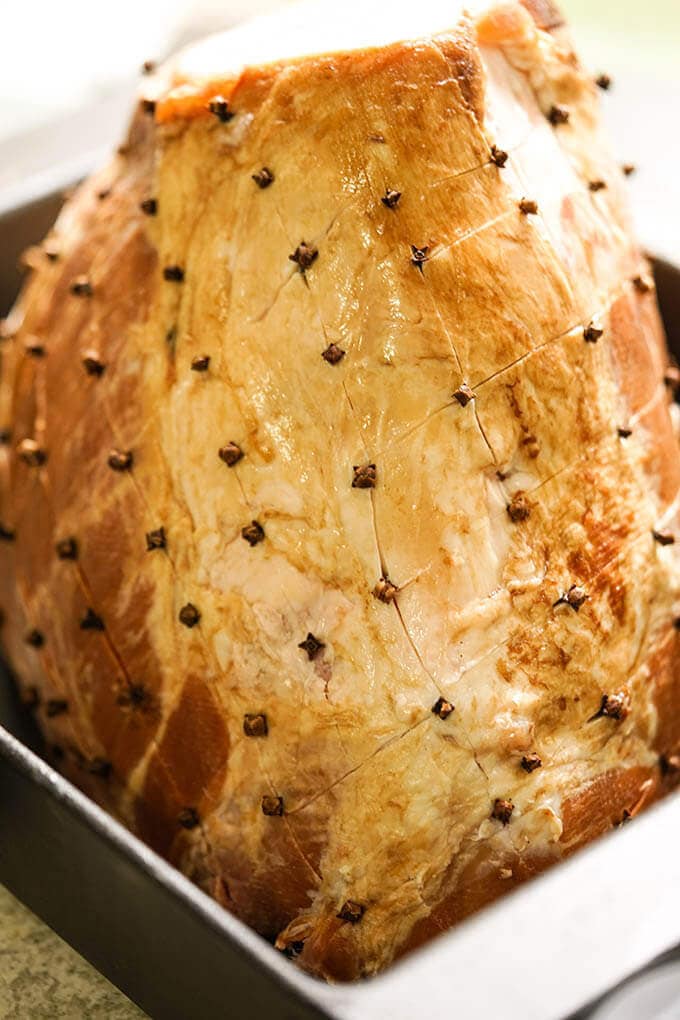 A ham with studded with cloves ready to bake.