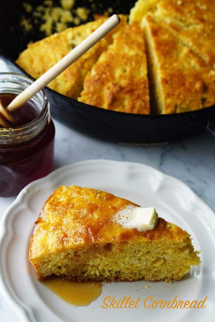 Cast Iron Skillet Cornbread Recipe sliced with a wedge of cornbread topped with melted butter and honey.