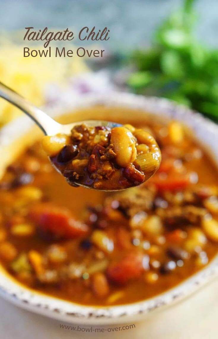 A hearty bowlful of chili with a big spoonful ready to gobble up!