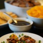 A platter of appetizers surrounded by all the fixings.