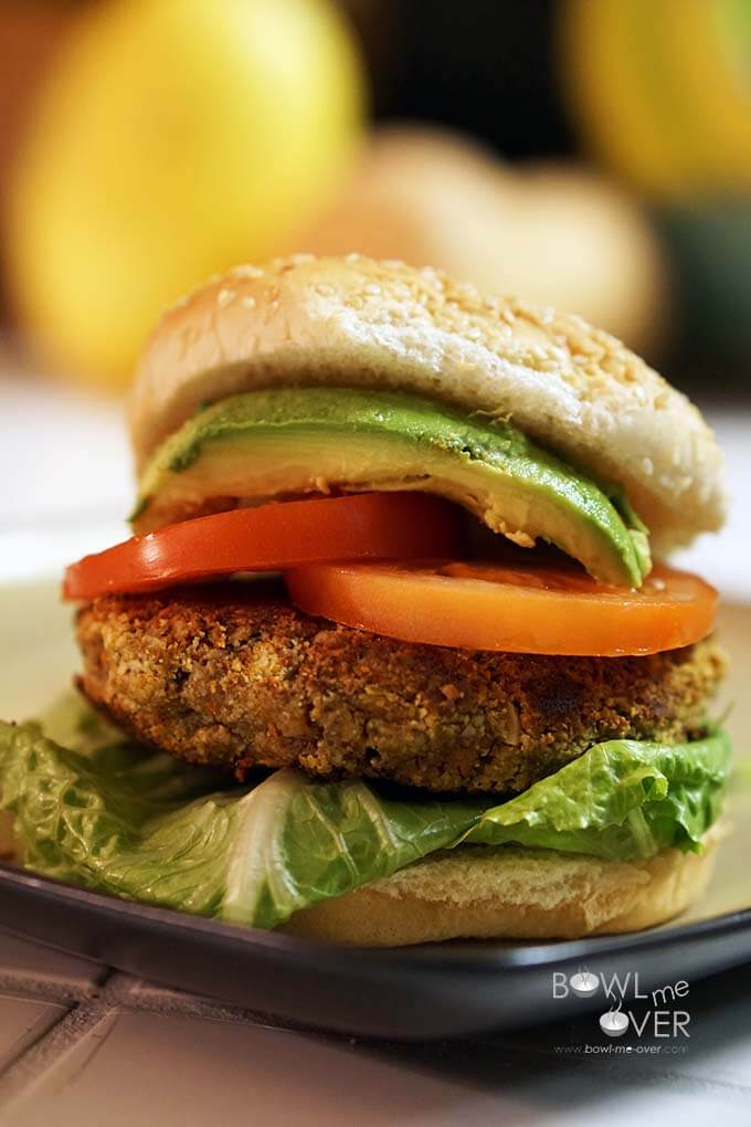 Nut Burger on bun, topped with sliced tomato and avocado. 