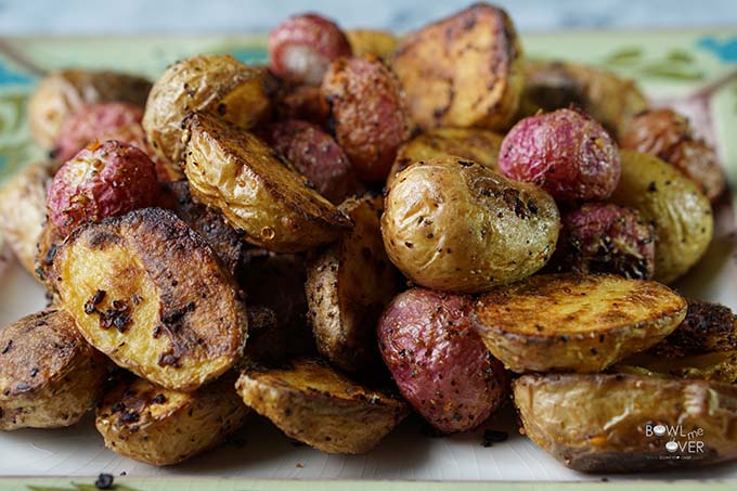 Roasted Potatoes and radishes on green platter.