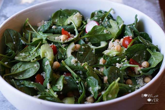 Spinach garbanzo bean salad in white bowl.