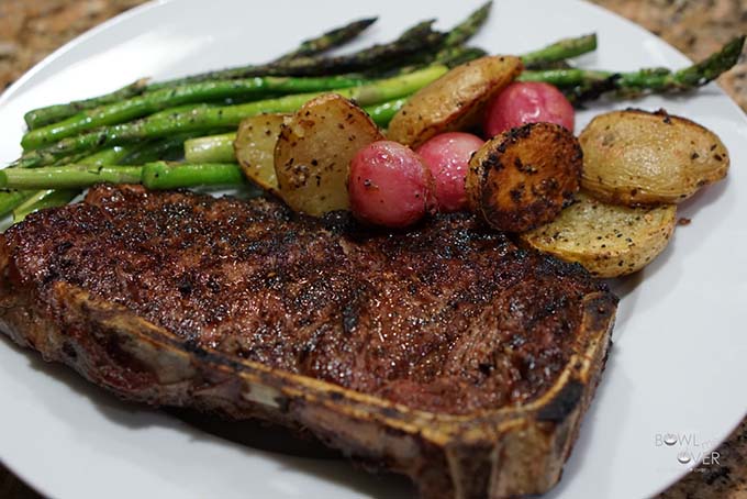 Grilled steak, asparagus and radishes on plate..