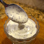 Panera Poppy Seed Dressing in bowl with spoon.