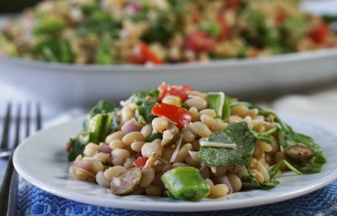 Mediterranean White Bean Salad heaped on a plate. 