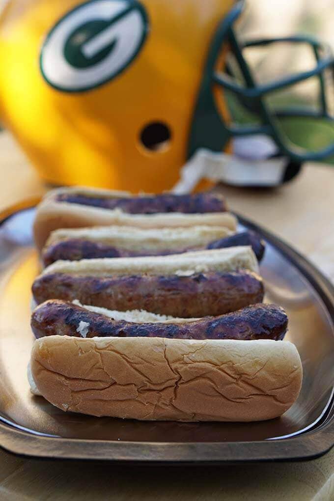 Beer Brats in buns on platter.