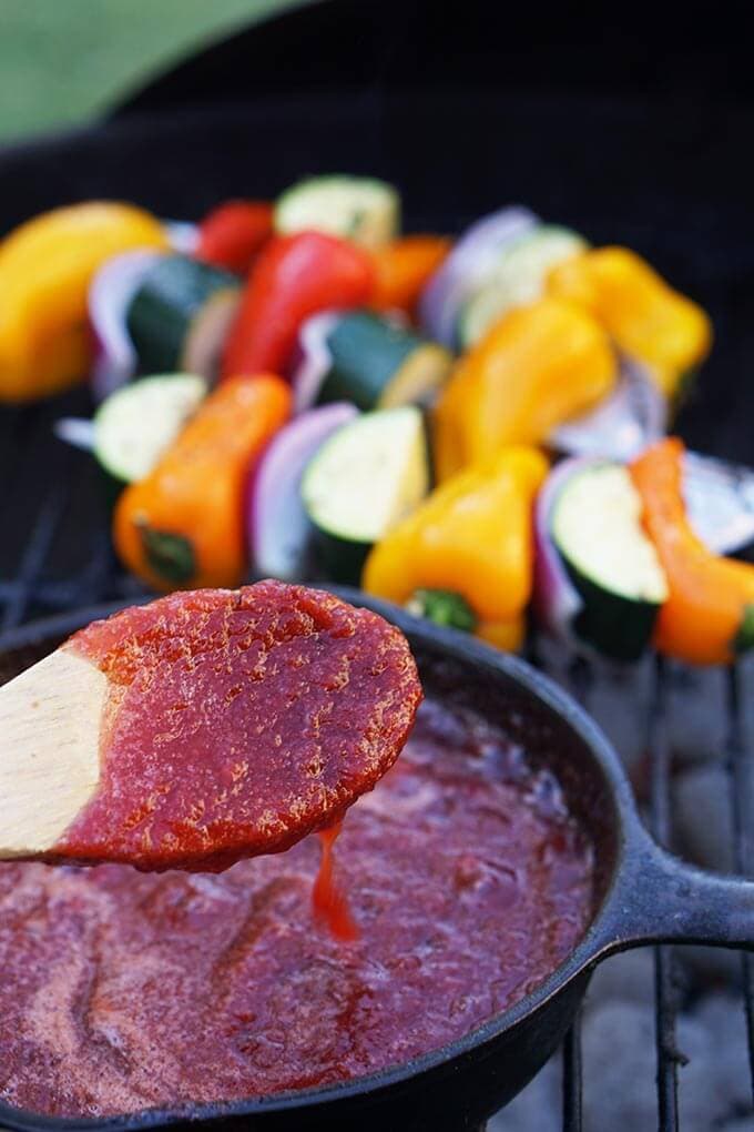 Plum BBQ Sauce in skillet with spoon.