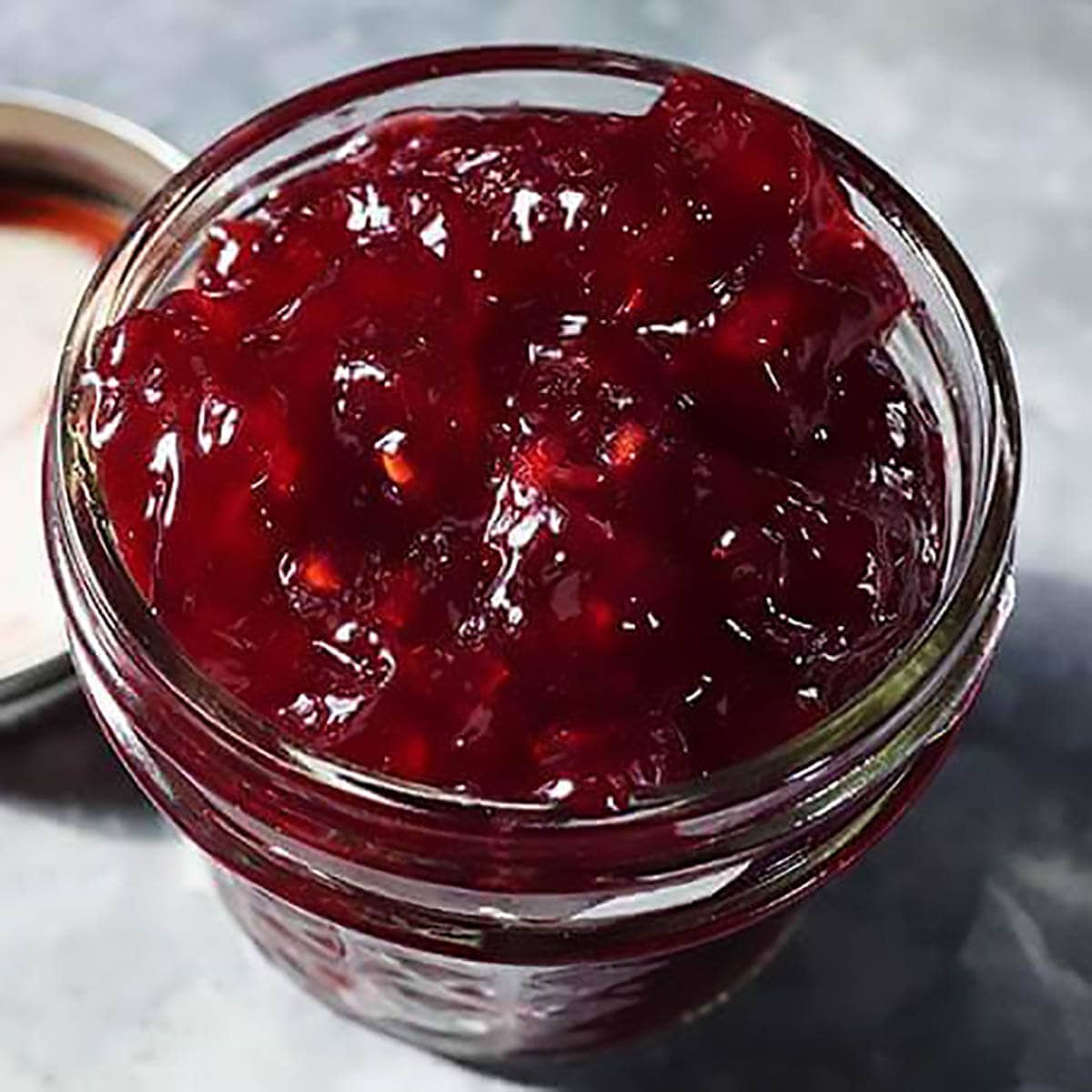 Pomegranate Jam in mason jar.
