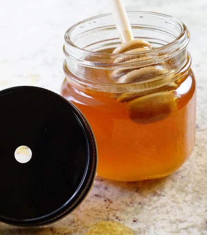Honey in jar with drizzler.