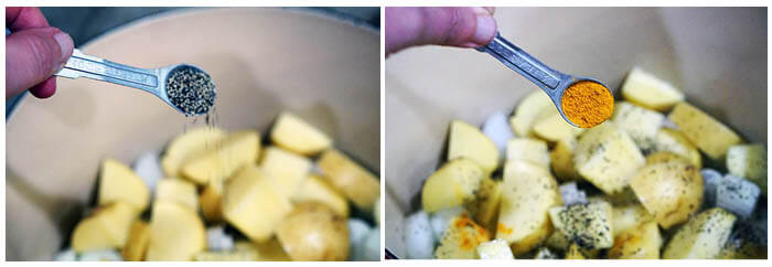 Soup in cooking pot being seasoned with spices.