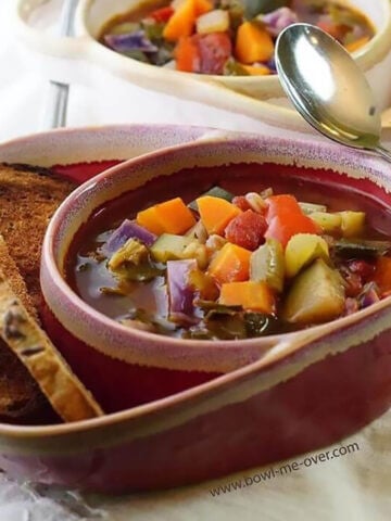 Carrabba's Minestrone Soup in bowl with crackers.