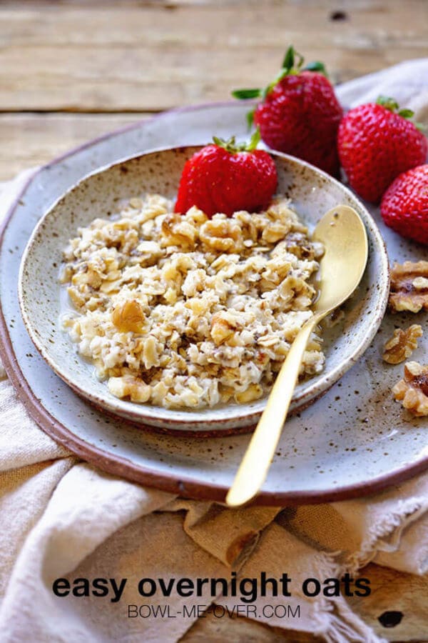 Oatmeal in a bowl topped with nuts and strawberries. With print overlay.