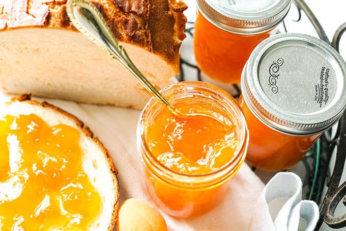 Apricot jam on a slice of bread.