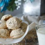 Grandma's Pecan Sandies Recipe. A while bowl filled with baked cookies and a glass of milk to dunk the cookies in!