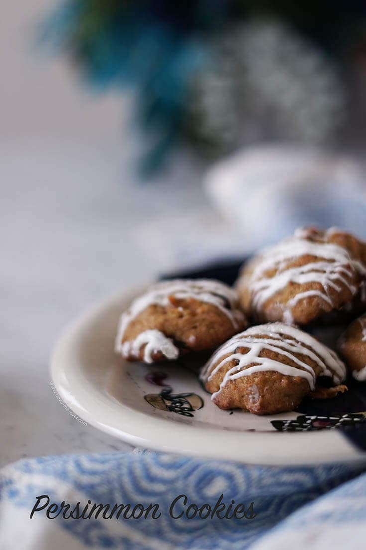 Persimmons Cookies drizzled with white chocolate on white plate.