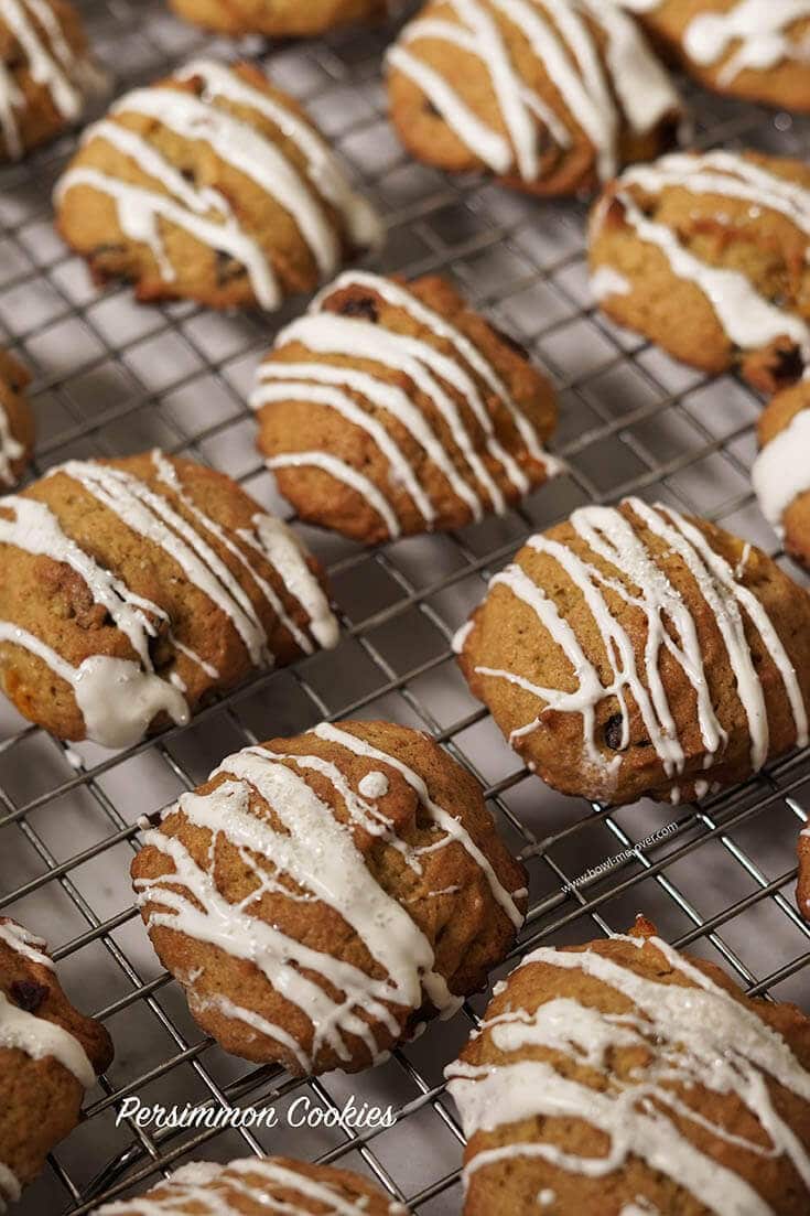 Persimmon Cookies drizzled with white chocolate on cooling rack.