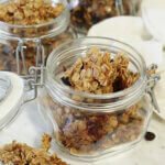 Cranberry granola in jars on board.