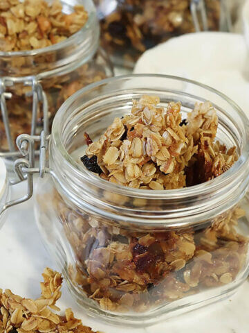 Cranberry granola in jars on board.