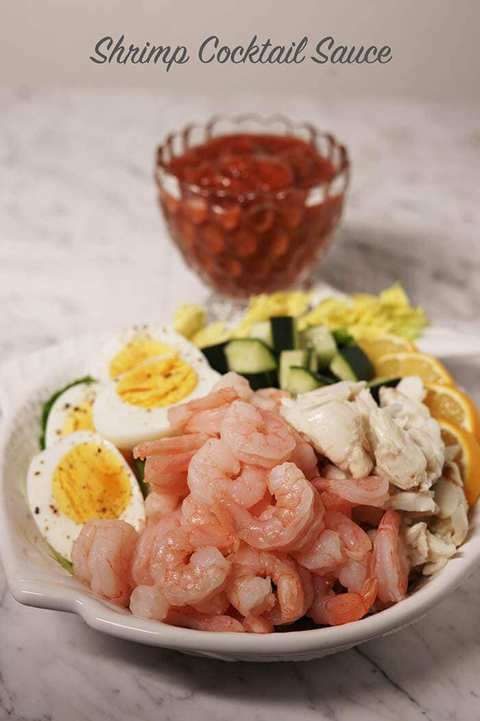 Shrimp salad on plate with shrimp cocktail sauce.