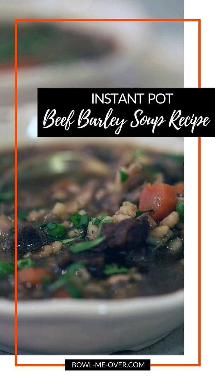 A white bowl full of delicious and hearty Beef Barley Soup!