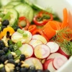 A green salad recipe with fresh vegetables, blueberries and pine nuts.