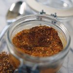 Homemade spice rub recipe in glass jar with spoon