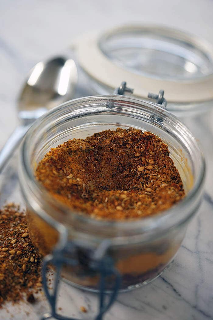 Homemade spice rub recipe in glass jar with spoon