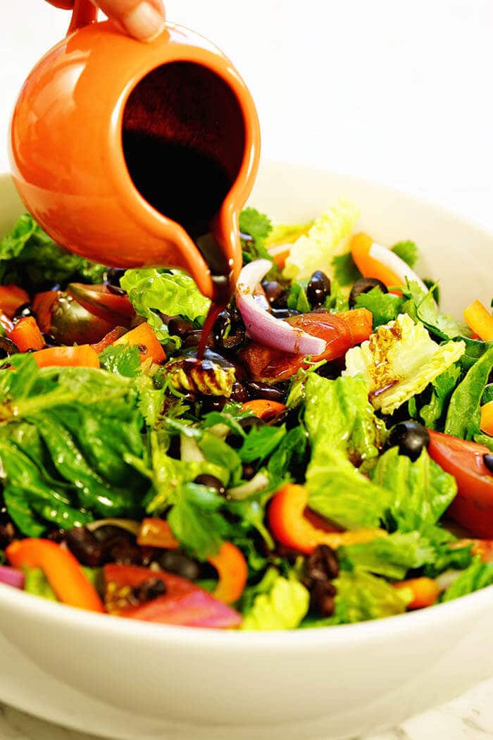 Southwest Salad Recipe in a big white bowl with a homemade vinaigrette drizzled over.