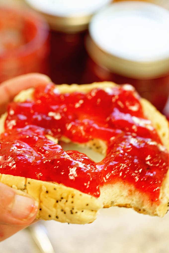 Bagel topped with homemade strawberry jam.