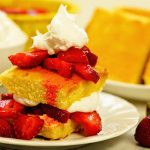 Easy strawberry shortcake piled high and topped with whipped cream