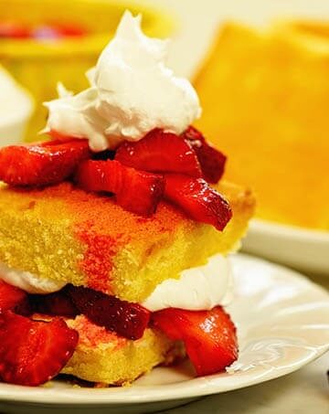 Easy strawberry shortcake piled high and topped with whipped cream