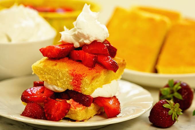 Easy strawberry shortcake piled high and topped with whipped cream