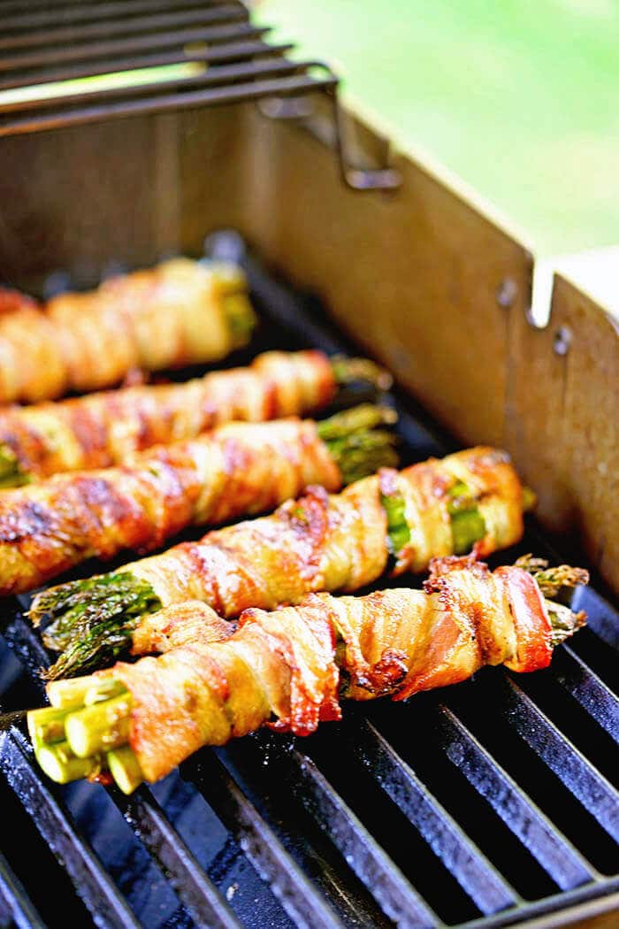 How to grill asparagus - Asparagus wrapped in bacon being cooked on the grill.