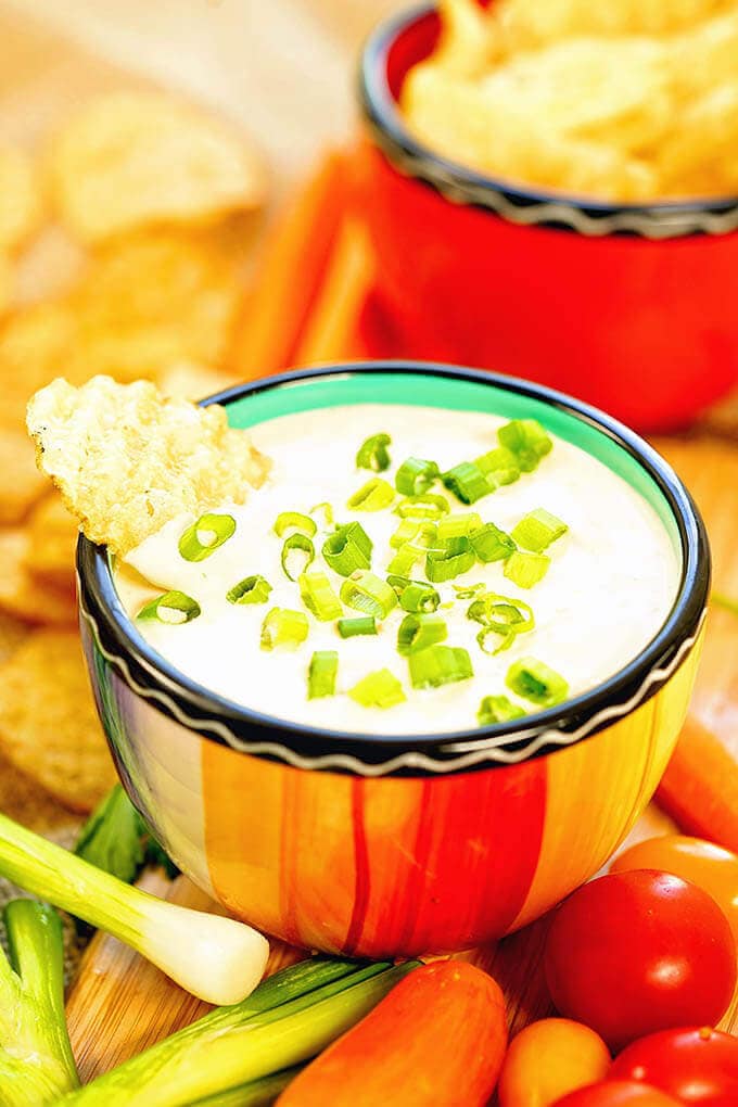 Homemade Onion Dip Recipe in a bright orange bowl surrounded by chips