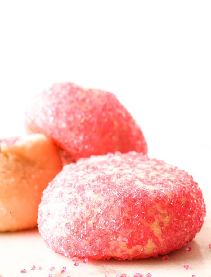 Three sugar cookies rolled in pink sugar.