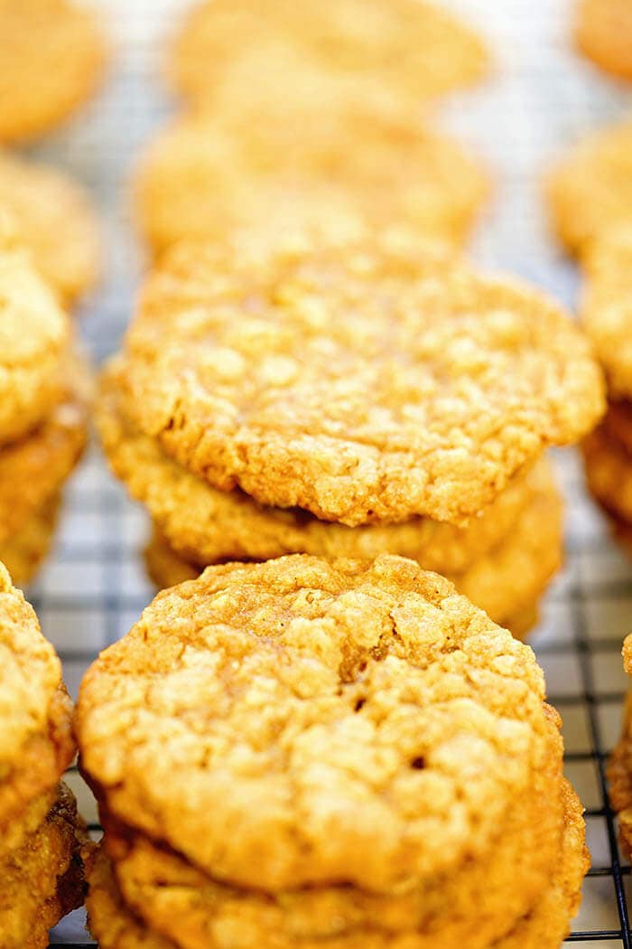 Stacks of easy oatmeal peanut butter cookies on a wire cooling rack.