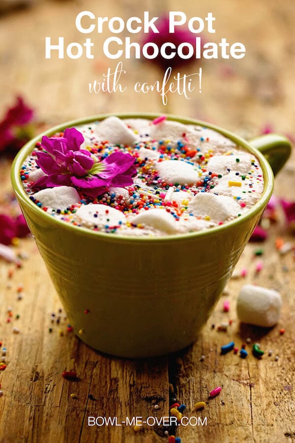 Slow Cooker Hot Chocolate Recipe in a green cup topped with marshmallows and sprinkles
