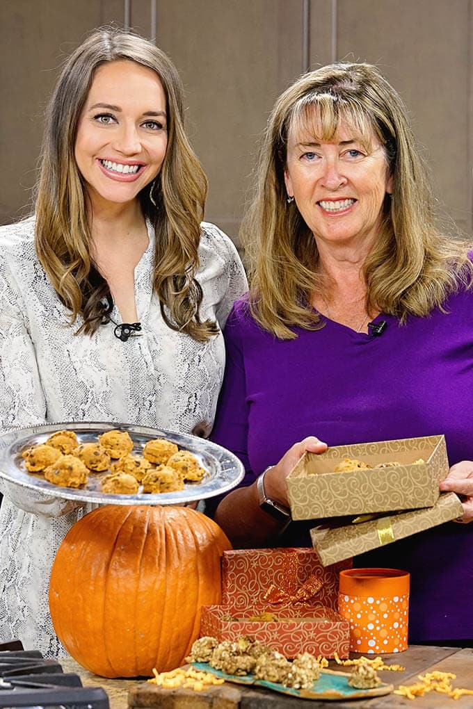 Christina and Deb holding a platter of cookies .