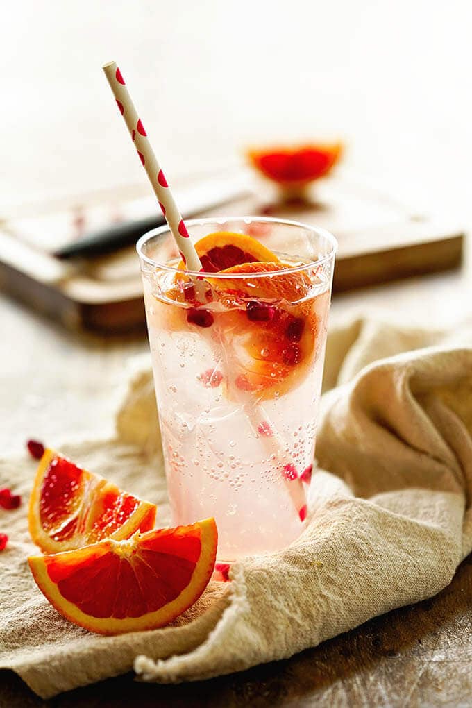Paloma Cocktail in a tall glass topped with blood orange garnish.