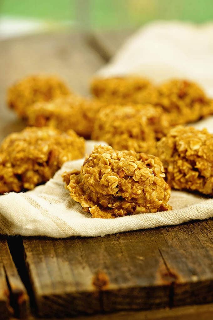 3 ingredient oatmeal cookies on a wooden board and white towel.