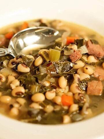 Black-eyed pea soup in bowl with spoon.