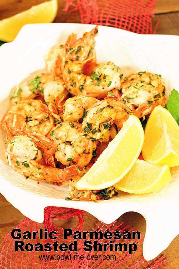 Roasted Air Fryer Shrimp in a white bowl with lemon wedges.