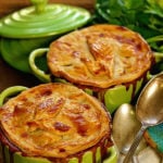 Two servings of turkey pot pie in little green ramekins.