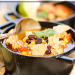Chicken Taco Soup in blast cast iron bowls with spoon.