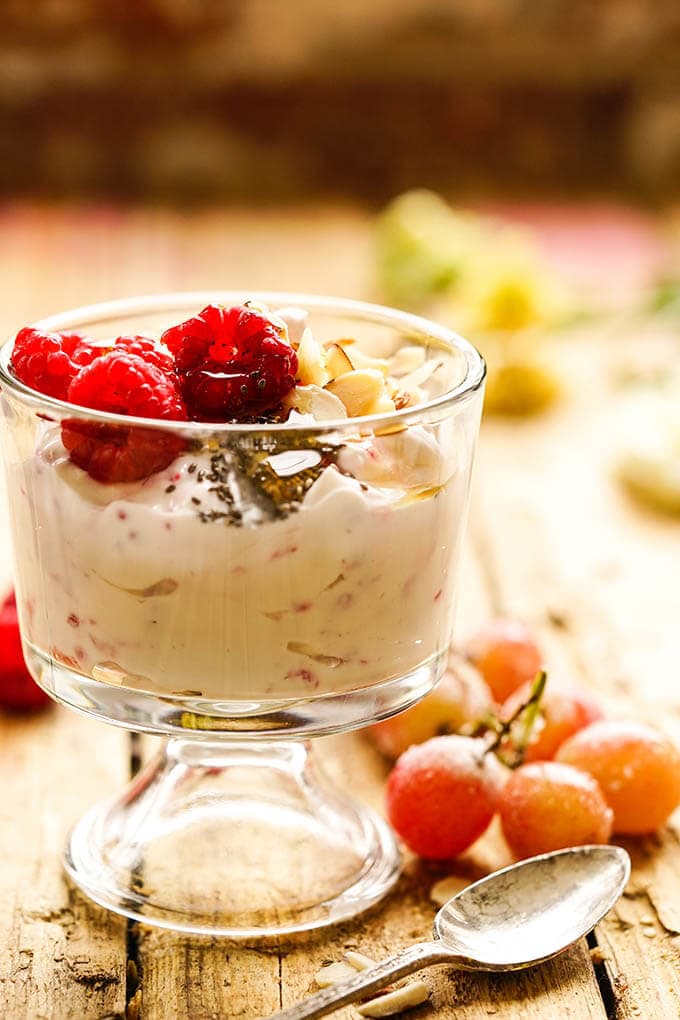 Make ahead breakfast Yogurt parfait topped with raspberries and sliced almonds