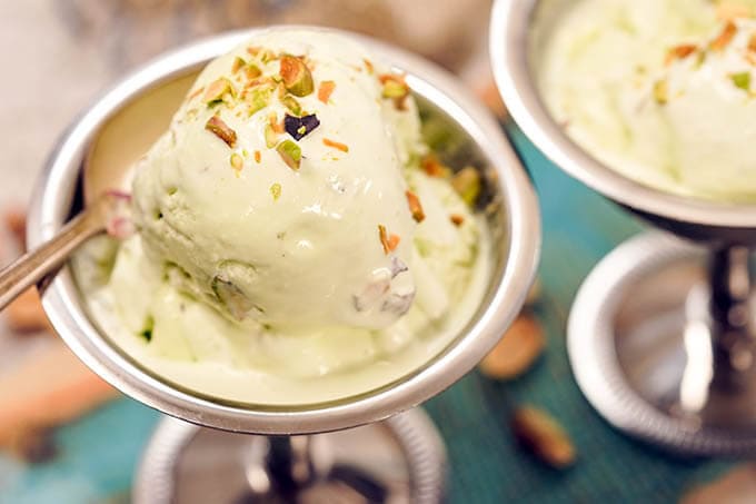 Homemade Pistachio Ice Cream Recipe in silver bowl with spoon.